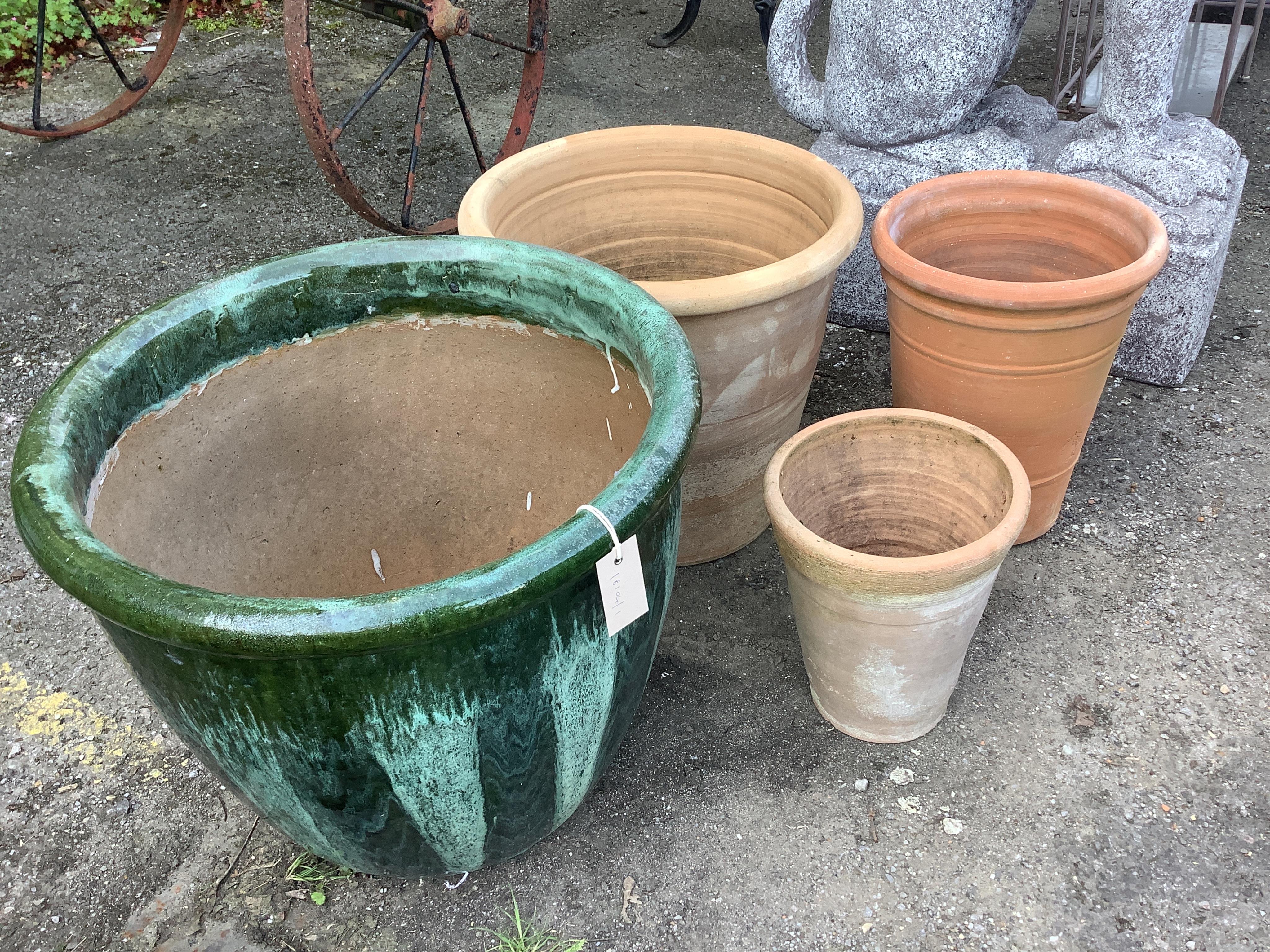 Three circular terracotta garden planters, largest diameter 49cm, height 41cm